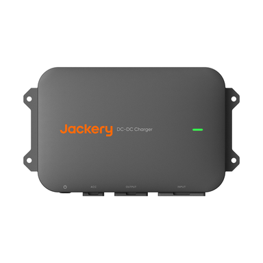 A black rectangular 600W Jackery DC-DC Charger with a green indicator light and three bottom ports labeled ACC, OUTPUT, and INPUT. The device includes side mounting flanges.