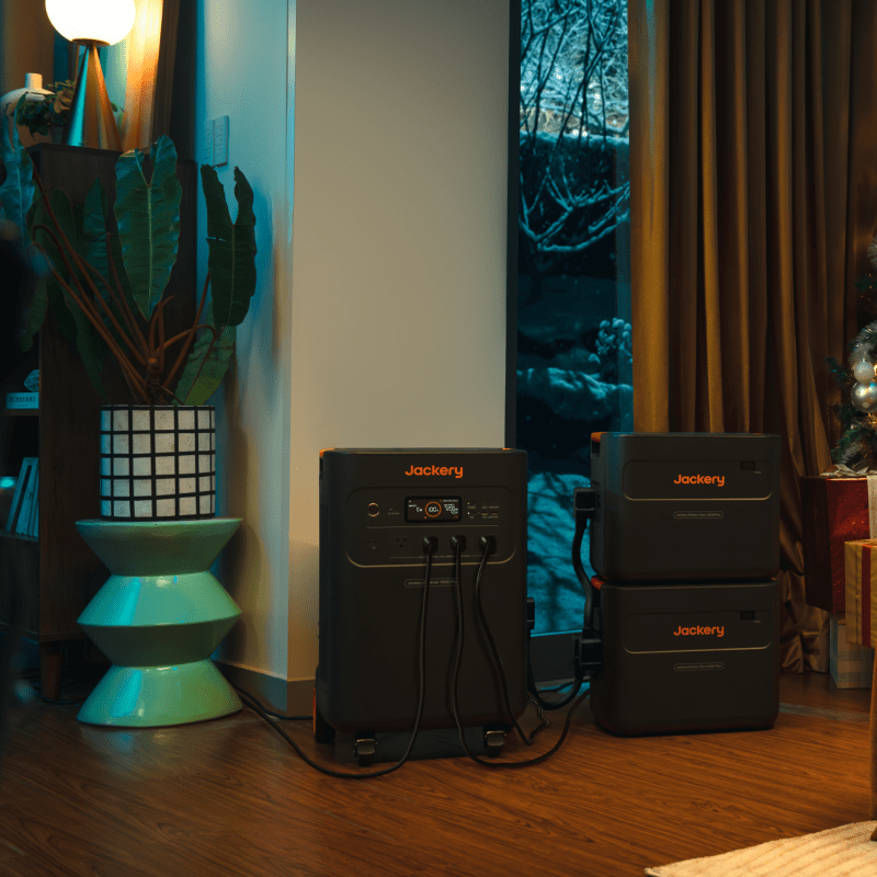 Jackery E5000Plus battery pack powering laptop in outdoor setting