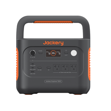 The Jackery Explorer 1000 portable power station features fast charging, a display screen, several AC outlets, DC and USB ports, and an orange handle. Shown from the front against a white background. Brand: Jackery.