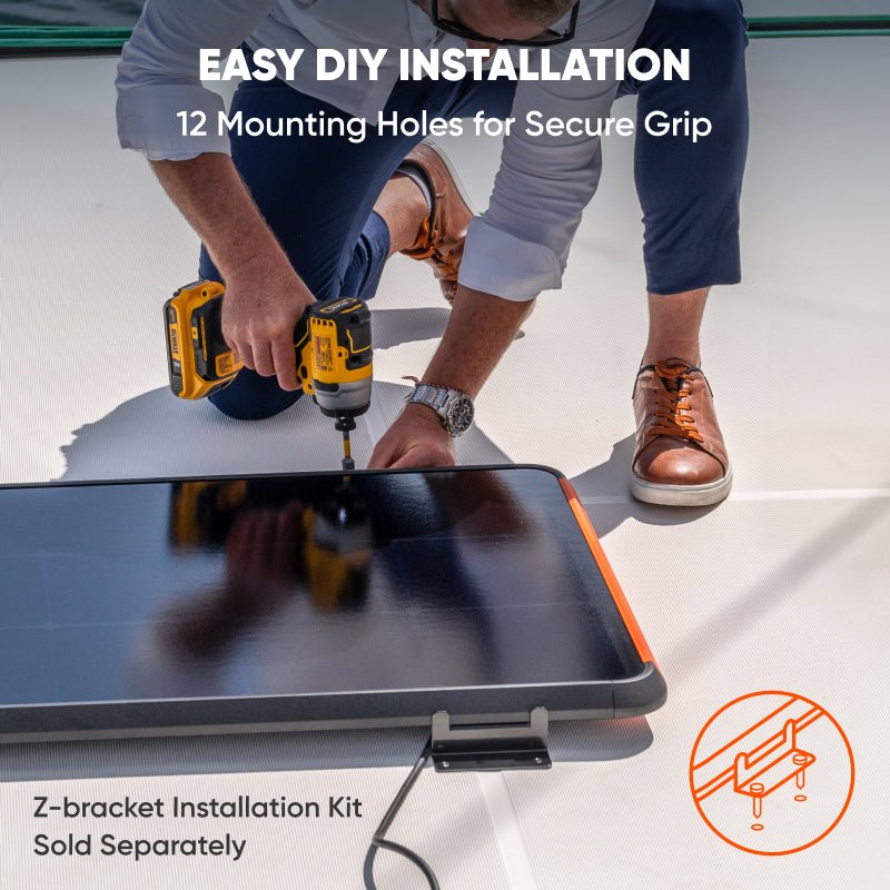 A person uses a power drill to install a Jackery SolarSaga 100 solar panel on a flat surface. Text: “Easy DIY installation, 12 mounting holes for secure grip.” Z-bracket kit sold separately. Brand: Jackery.