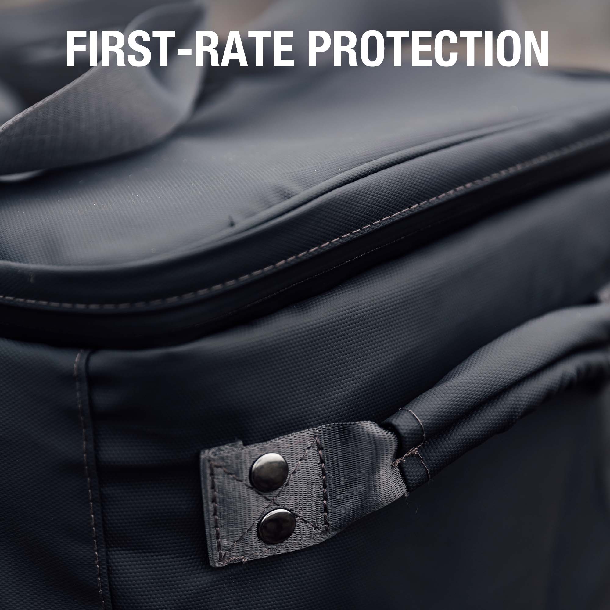Close-up of a dark-colored Jackery outdoor power station bag with a sturdy zipper and reinforced corner, featuring the text “FIRST-RATE PROTECTION” in white at the top.