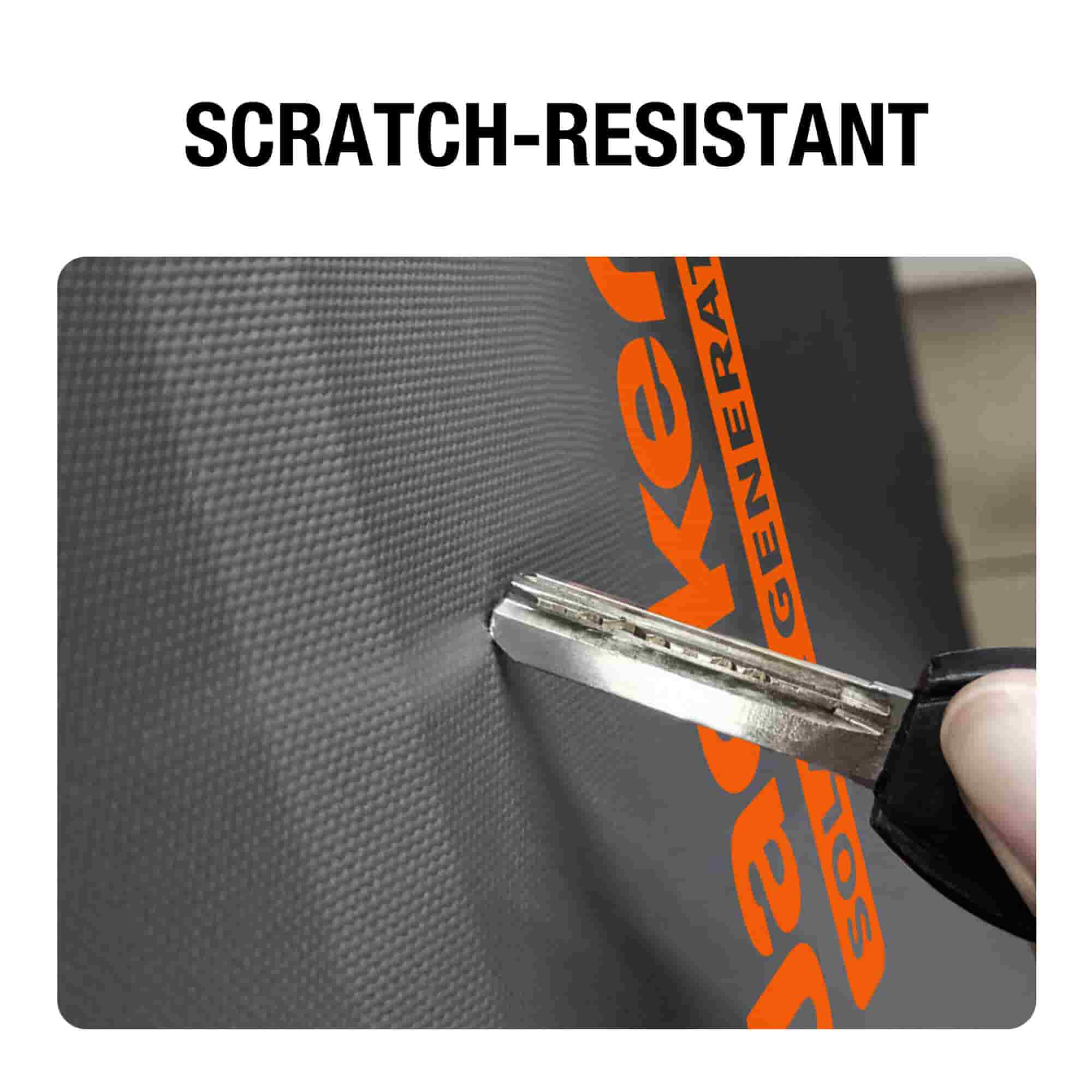 A close-up shows a key pressed against the textured black surface of the Jackery Explorer portable storage bag with orange text, highlighting its scratch-resistant material as no visible mark is left.