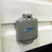 A gray, weatherproof 30 Amp Power Inlet Box from Nature's Generator is installed on white textured siding.