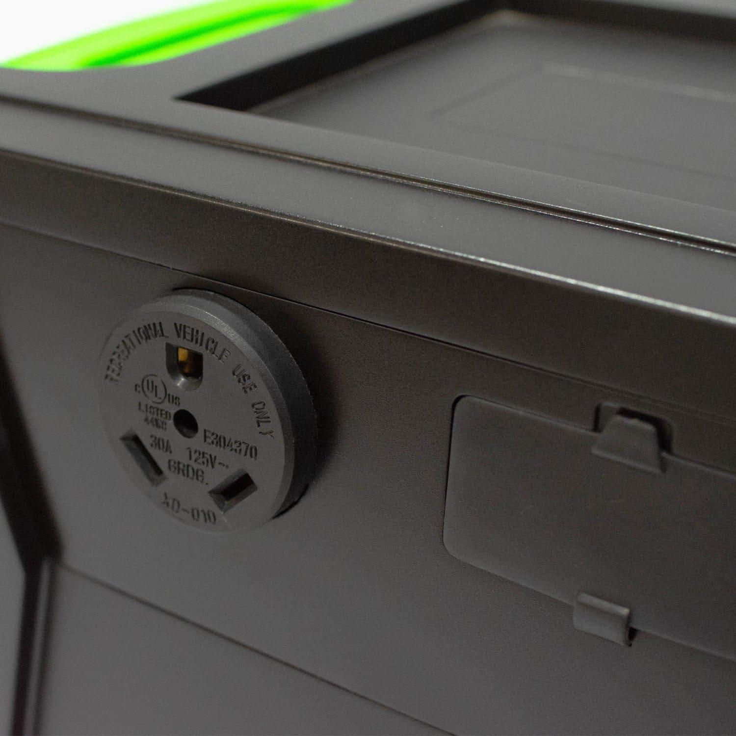 Close-up of a black plastic panel from Nature's Generator with an electrical outlet labeled "Recreational Vehicle Use Only" and a covered port, indicating compatibility with off-grid power or solar generators. A green edge appears at the top.