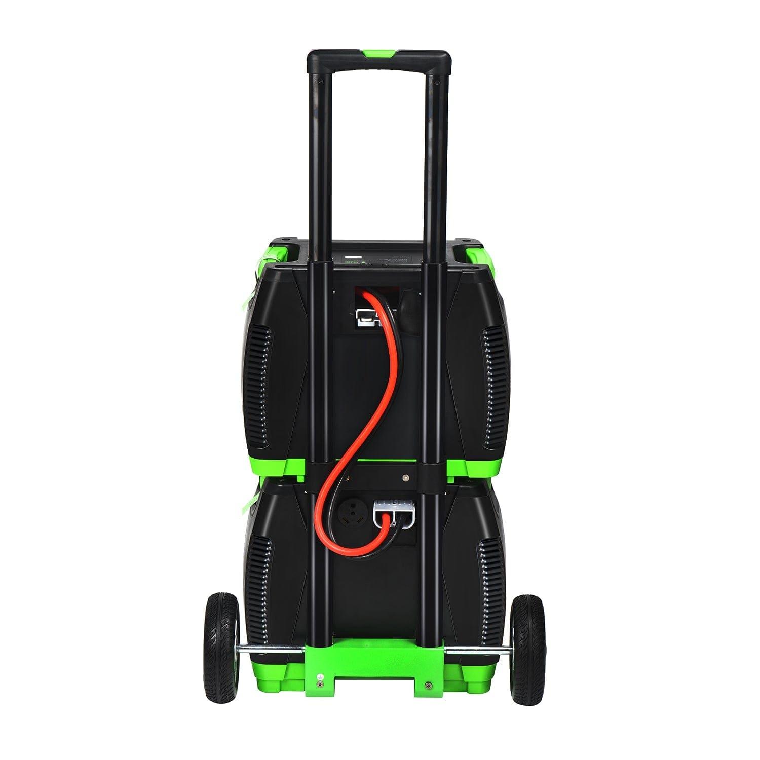 The Nature's Generator is a black and green portable solar generator with two stacked units, two wheels, a pull handle, and an orange power cable connected up front—perfect for home battery backup or off-grid power needs.