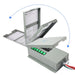 A Nature's Generator gray metal electrical box for a whole house generator, featuring green labeled switches, attached wiring, and instruction sheets inside, is shown with its hinged lid opening upward and to the side in three stages.