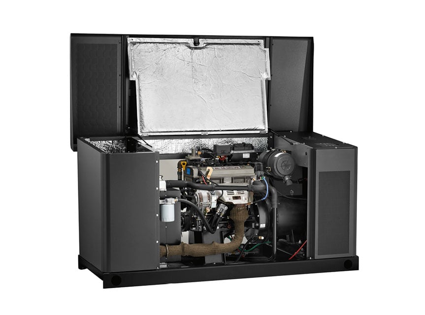 A large Briggs & Stratton commercial standby generator with its top cover lifted reveals the engine, wiring, filters, and metal parts inside. The dark code-compliant exterior casing features visible insulation in the raised top cover.