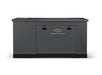 A large, rectangular Briggs & Stratton standby generator with a dark gray finish, flat top, front panel, and center logo delivers automatic code-compliant backup power; pictured on a white background.