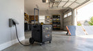 Pecron F5000LFP portable power station set up as whole-home backup power in a garage