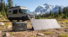 Pecron PV200 200W solar panel charging a Pecron power station beside a camper van