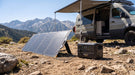 Pecron PV300 300W solar panel charging a Pecron power station beside a camper van