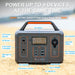 The ALLWEI US portable power station features a handle, labeled ports, digital display, AC outlets, DC output, USB ports, cigarette lighter, on/off buttons, 600W peak output, and powers up to 9 devices—ideal as a backup battery.