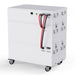 The Nature's Generator is a large, rectangular white battery storage unit for solar panel systems, featuring multiple stacked compartments, front black and red cables, metal side handles, and four base casters for easy mobility.